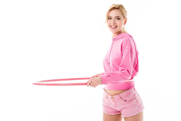 Young girl wearing pink exercising with hula hoop isolated on white — Stock Photo