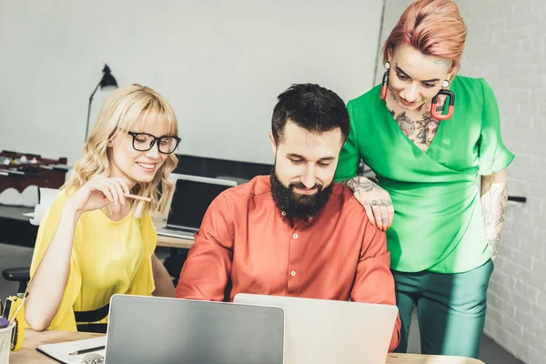 Group of young creative workers discussing new project together in office — Stock Photo