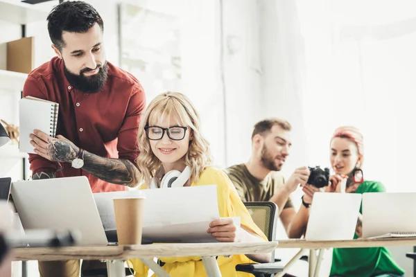 Selective focus of group of young creative workers working in office — Stock Photo