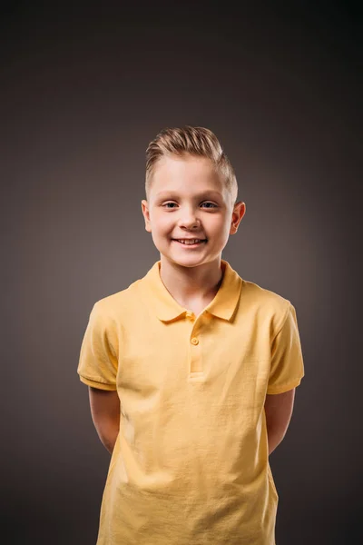 Adorable preteen smiling boy, isolated on grey — Stock Photo