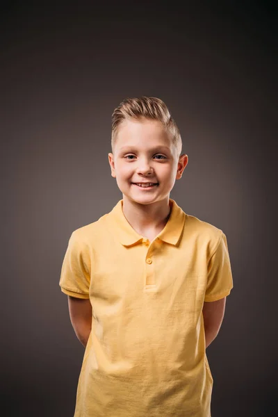 Adorable preadolescente sonriente chico, aislado en gris - foto de stock