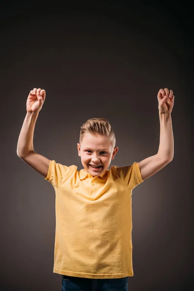 Preteen smiling boy gesturing, isolated on grey — Stock Photo