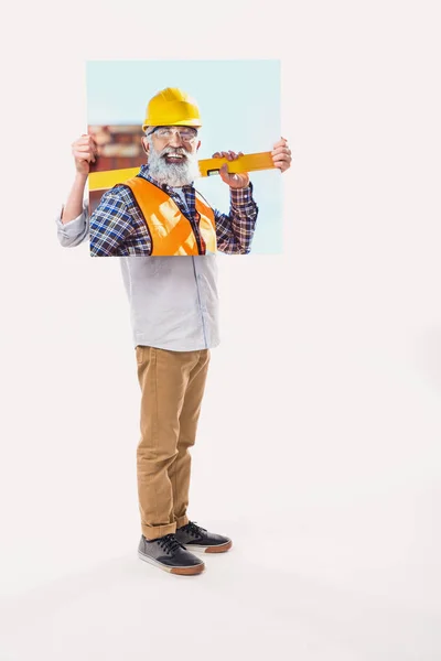 Menino fingindo ser construtor profissional, isolado no branco — Fotografia de Stock