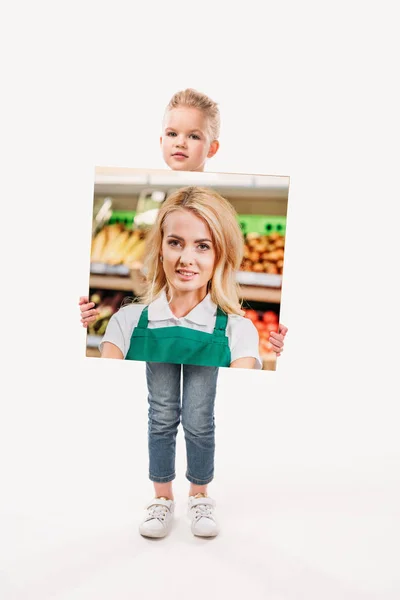 Beautiful kid pretending to be saleswoman, isolated on white — Stock Photo