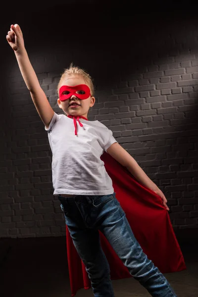 Female child flying in red superhero mask — Stock Photo