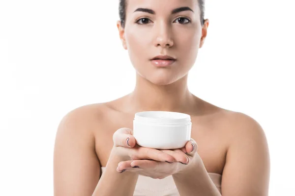 Beautiful girl showing moisturizing cream isolated on white — Stock Photo