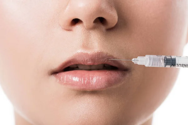 Cropped image of cosmetologist making beauty injection in lips to girl with clean skin isolated on white — Stock Photo