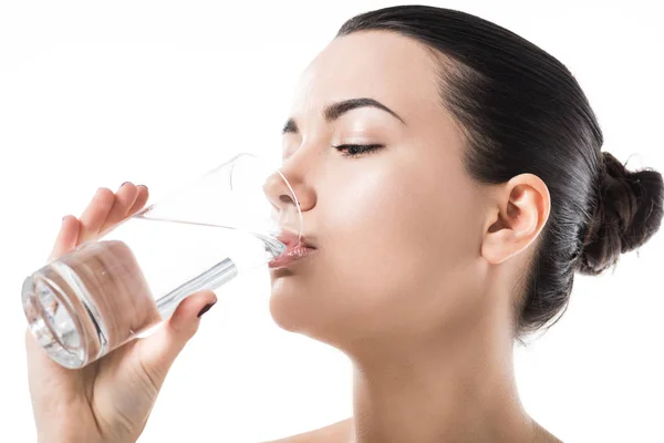 Side view of beautiful girl drinking water from transparent glass isolated on white — Stock Photo