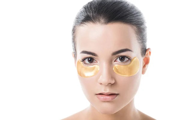 Beautiful brunette girl with moisturizing under eyes patches looking at camera isolated on white — Stock Photo