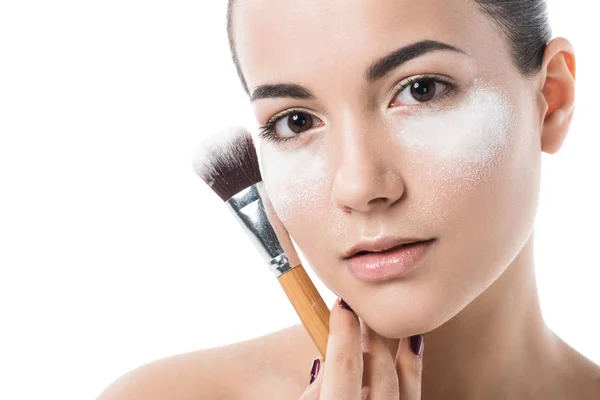 Beautiful girl with face powder under eyes looking at camera isolated on white — Stock Photo