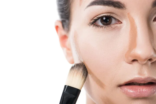 Cropped image of beautiful girl applying foundation cream with brush isolated on white — Stock Photo