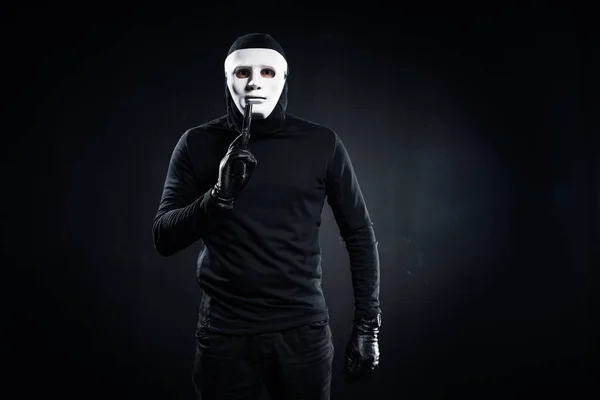 Robber in mask and balaclava holding gun — Stock Photo