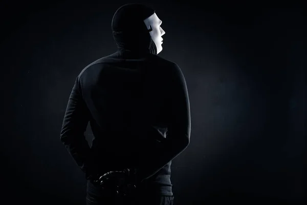 Rear view of male criminal in mask and balaclava — Stock Photo