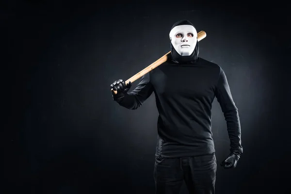 Burglar in mask and balaclava holding baseball bat — Stock Photo