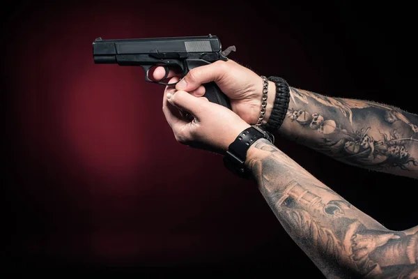 Close-up view of male hands aiming with gun — Stock Photo