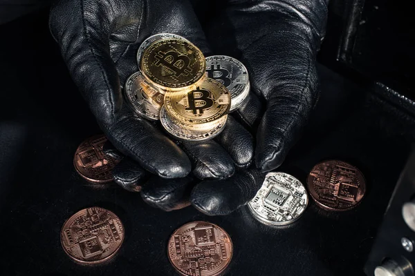 Stack of bitcoin in hands of thief wearing gloves — Stock Photo