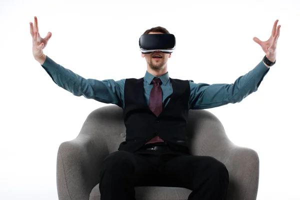 Portrait of agent in virtual reality headset sitting in armchair isolated on white — Stock Photo