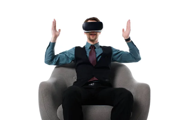 Portrait of agent in virtual reality headset sitting in armchair isolated on white — Stock Photo