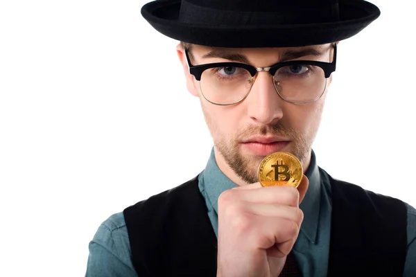 Portrait of spy in eyeglasses and hat holding golden bitcoin isolated on white — Stock Photo