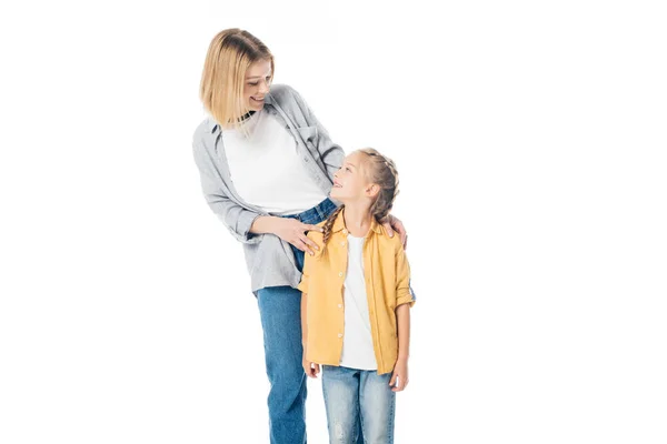 Smiling mother and little daughter looking at each other isolated on white — Stock Photo