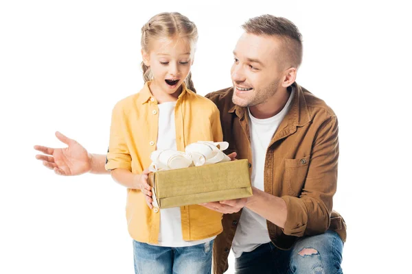 Portrait of father giving wrapped present with shocked daughter isolated on white — Stock Photo