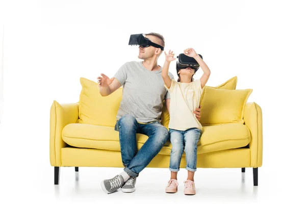 Pai e filha em fones de ouvido realidade virtual no sofá amarelo isolado em branco — Fotografia de Stock