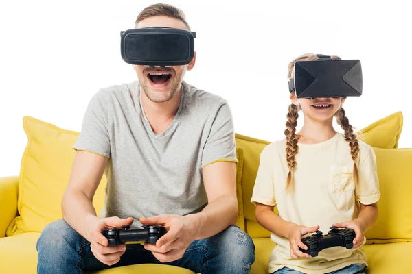 Family with joysticks in virtual reality headsets playing video game isolated on white — Stock Photo