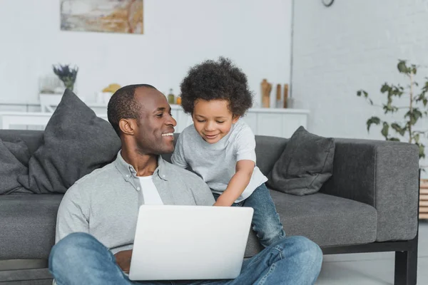 Padre e figlio utilizzando il computer portatile — Foto stock