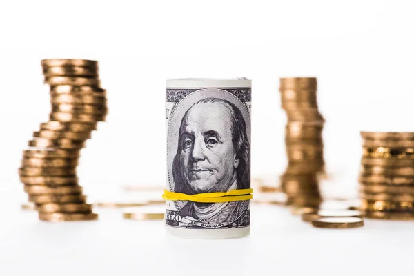 Close-up view of rolled dollar banknotes and stacked coins isolated on white — Stock Photo