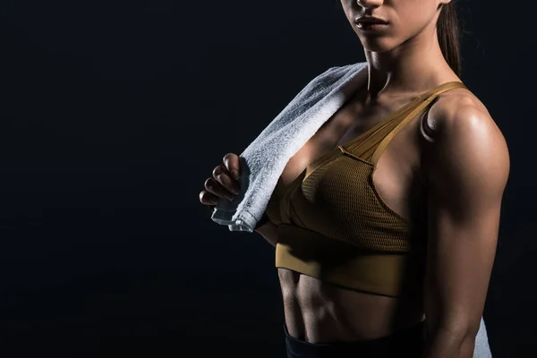 Cropped view of sweaty muscular bodybuilder with towel, isolated on black — Stock Photo