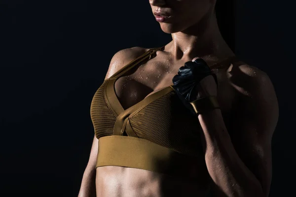 Partial view of sexy sweaty muscular bodybuilder, isolated on black — Stock Photo