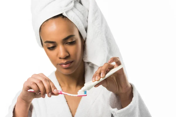 African american woman with toothpaste and toothbrush,  isolated on white — Stock Photo