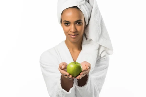 Beautiful african american woman in towel holding organic apple,  isolated on white — Stock Photo