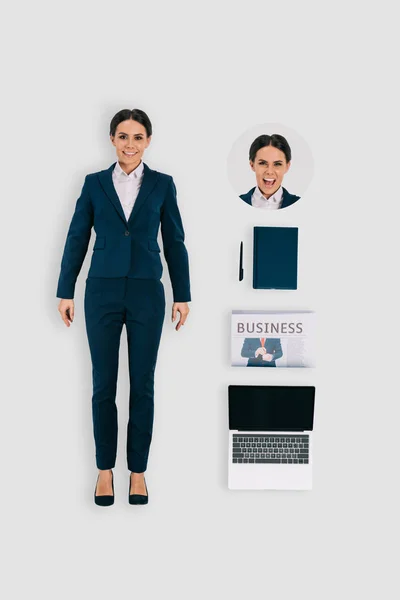 Vue du dessus de femme d'affaires avec ordinateur portable, journal et manuel isolé sur fond blanc — Photo de stock