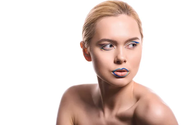 Schöne Frau mit farbigem Make-up mit Linien, die auf Weiß isoliert wegschauen — Stockfoto