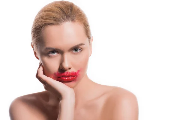 Beautiful woman with smeared red lipstick on face isolated on white — Stock Photo