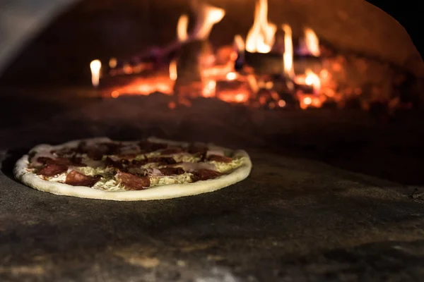 Close up view of italian pizza baking in brick oven in restaurant — Stock Photo