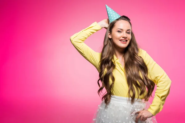 Attractive woman posing with party hat isolated on pink — Stock Photo