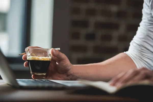 Human hand holding glass of beverage — Stock Photo, Image