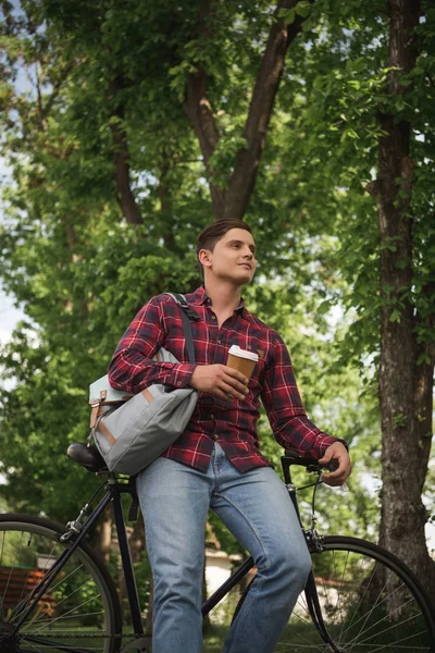 Man in checkered shirt at park — Stock Photo, Image