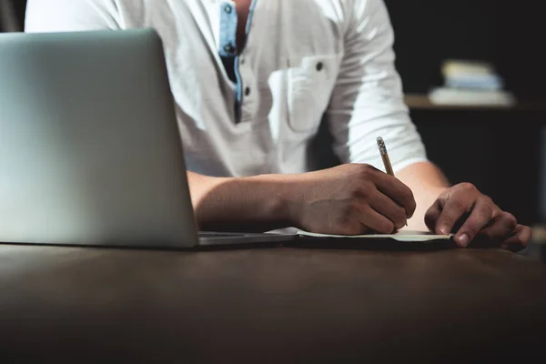 Man writing in notebook his plans Stock Picture