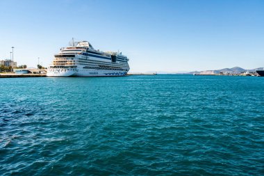 PIRAEUS, GREECE - APRIL 10, 2020: cruise ship with aidabella lettering in aegean sea  clipart