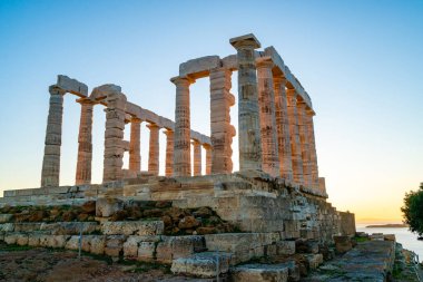 ancient columns of parthenon against blue sky  clipart