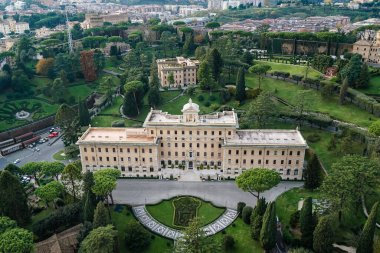 ancient building near green gardens of Vatican clipart