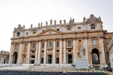 VATICAN CITY, ITALY - APRIL 10, 2020: ancient st peters basilica with statues on rooftop  clipart