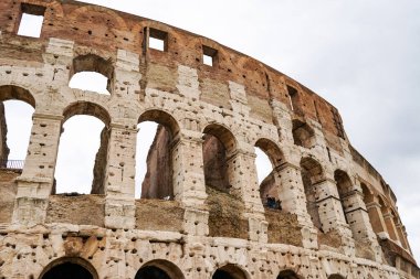 ancient Colosseum against sky with clouds in rome  clipart