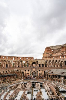 ROME, ITALY - APRIL 10, 2020: historical Colosseum against sky with clouds in rome  clipart
