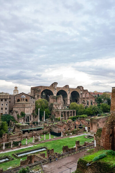 old buildings of rome against blue sky with clouds 