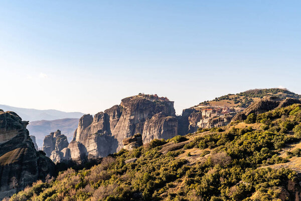 rock formations with monastery near mountains in meteora 
