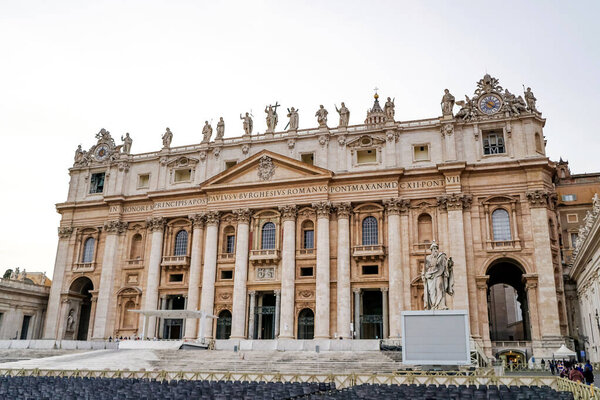 VATICAN CITY, ITALY - APRIL 10, 2020: ancient st peters basilica with statues on rooftop 